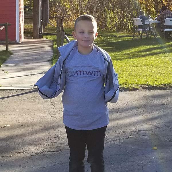 young boy wearing mwm shirt